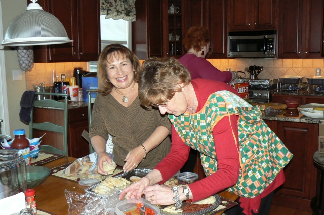 Robin Buzzelli Carpenter and Carolyn Trout Petteway help prepare the food for the event.