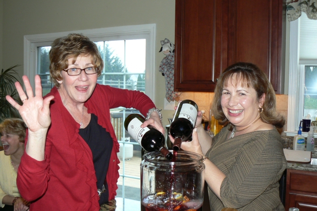 Gotta have beverages, and we had plenty!  Carolyn Trout Petteway and Robin Buzzelli Carpenter prepare the Sangria.